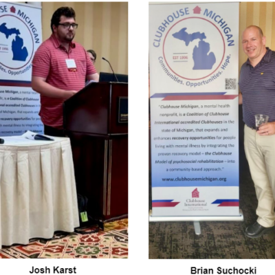 Two men, Josh Karst and Brian Suchocki, are standing in front of "Clubhouse Michigan" banners. Josh is speaking at a podium on the left, and Brian holds a drink on the right.